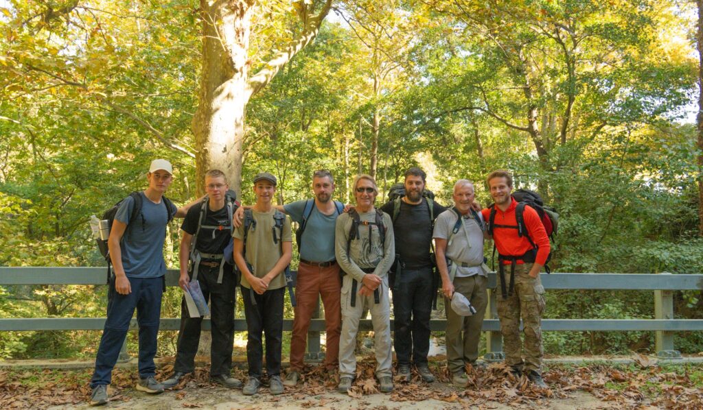 Group of men from the Path of Manliness brotherhood standing together on a forest hike